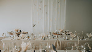 dried arrangements down long table with white drape hanging wedding