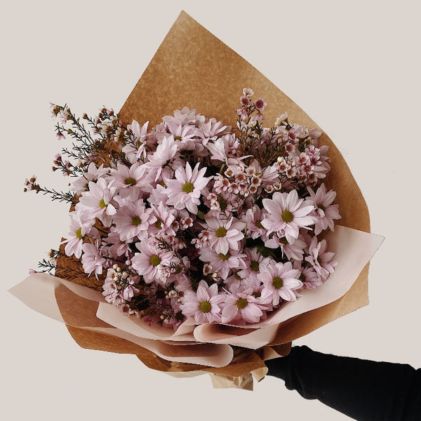 Light pink spray mums bouquet wrapped in kraft paper mixed with wax flower. Large size.