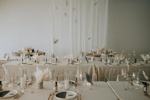 Wedding at the Polygon Gallery in North Vancouver with white walls and drapery and netural dried flower arrangements on long tables