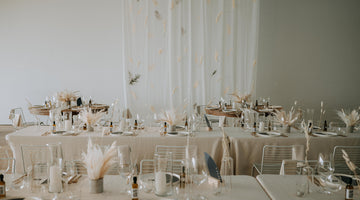 Wedding at the Polygon Gallery in North Vancouver with white walls and drapery and netural dried flower arrangements on long tables