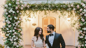 large floral archway framing couple