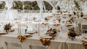 fall wedding reception with fall arrangements on long tables