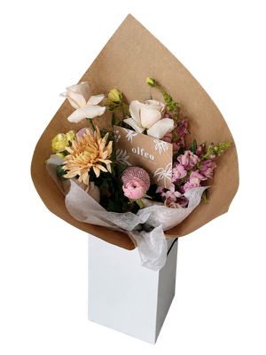 Bouquet of flowers wrapped in brown paper with a white box underneath on a white background for Delivery in Vancouver