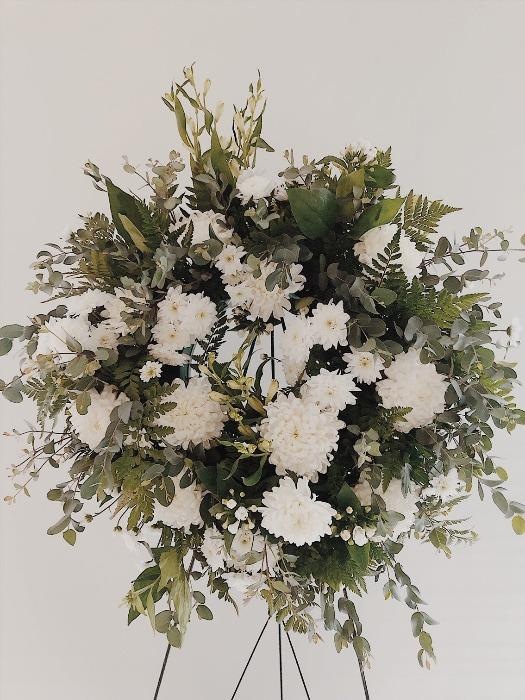Green and white funeral wreath with stand