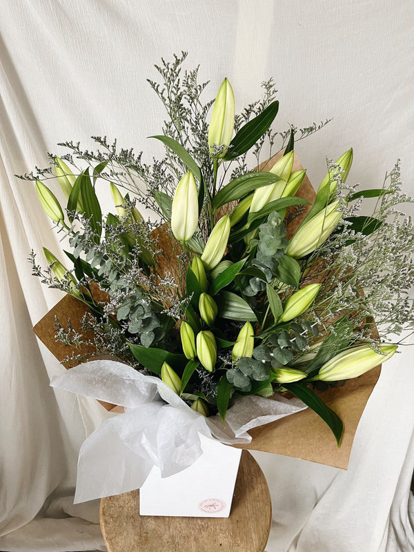 Closed bloom white lily bouquet for delivery