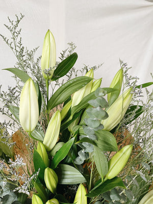 Close up of closed white lily bouquet for delivery
