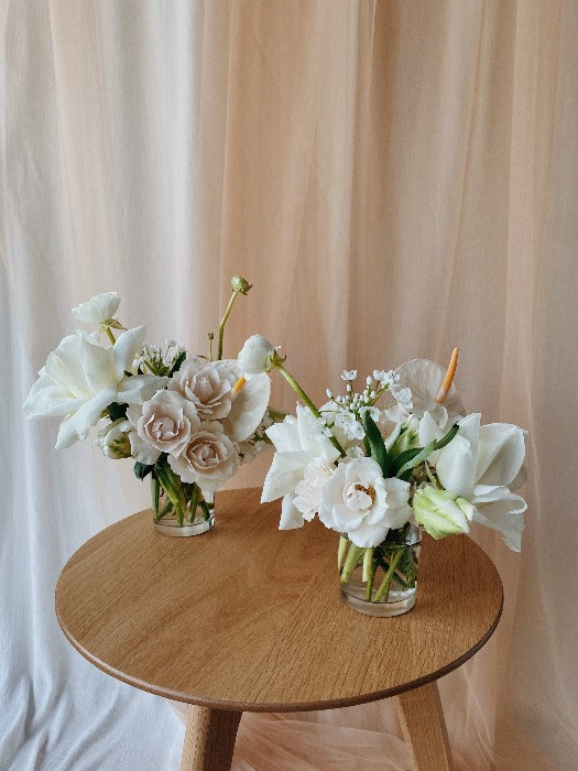 White, green and blush flowers in clear cocktail vase